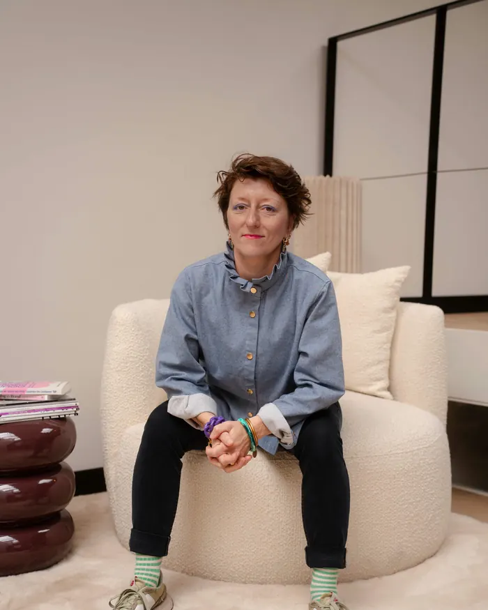 Dorothy Seguy sitting in a white armchair